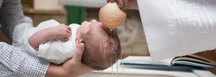 Baby receiving sacrament of Baptism