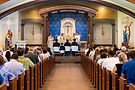 Archbishop Aquila celebrates Mass at Holy Trinity Catholic Parish with parishioners filling the pews